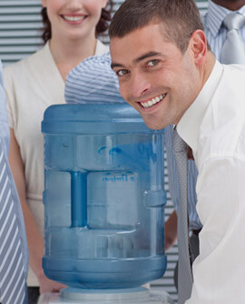 An office worker carrying a large water bottle for the cooler
